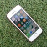 silver iphone on a green grass